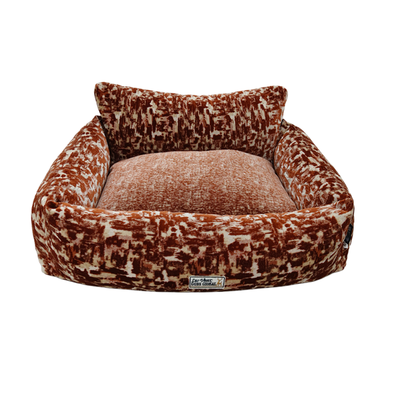 Rust pattern bolster dog bed with cushioned sides and padded sleeping area